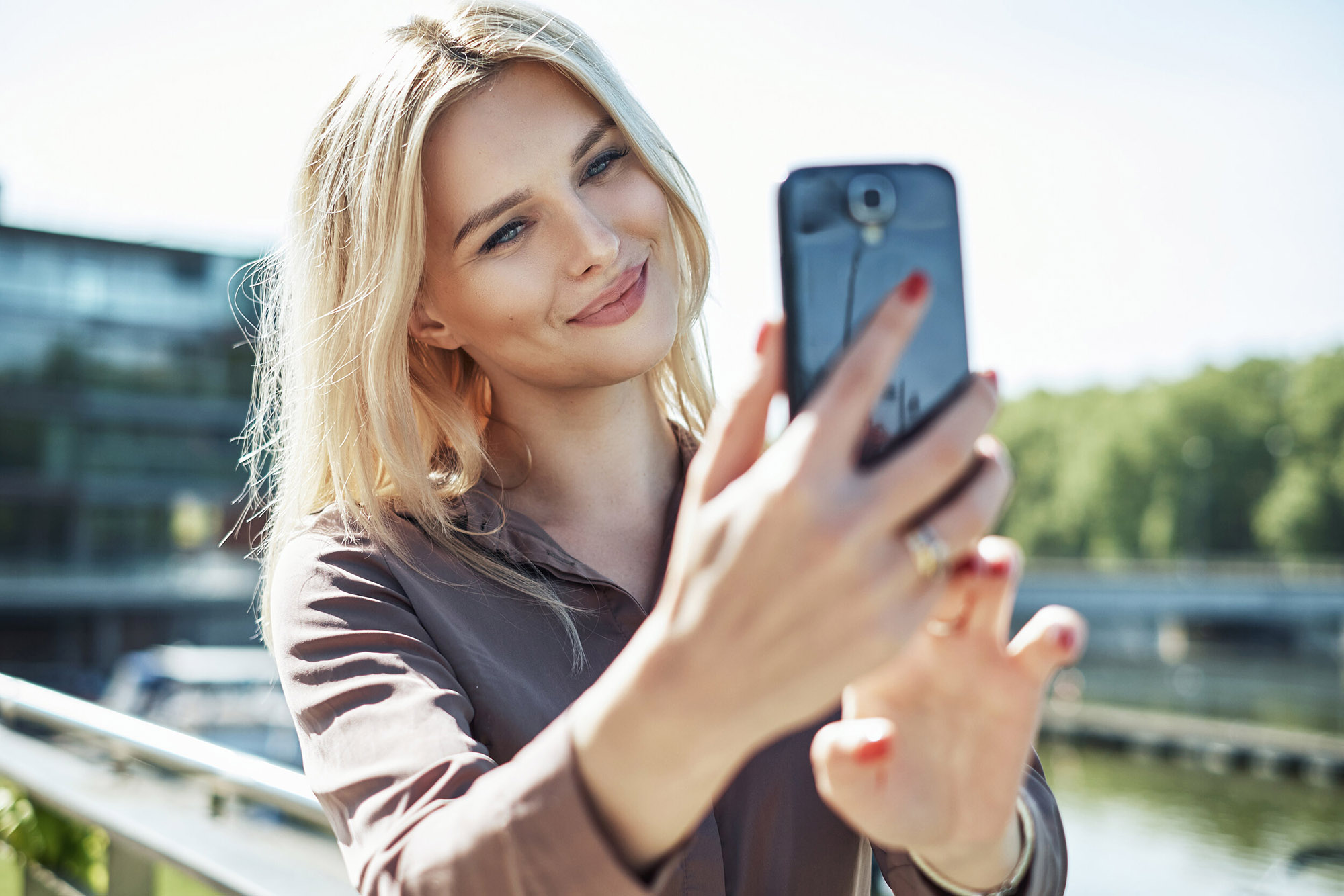 Portrait of a blond woman taking a selfie