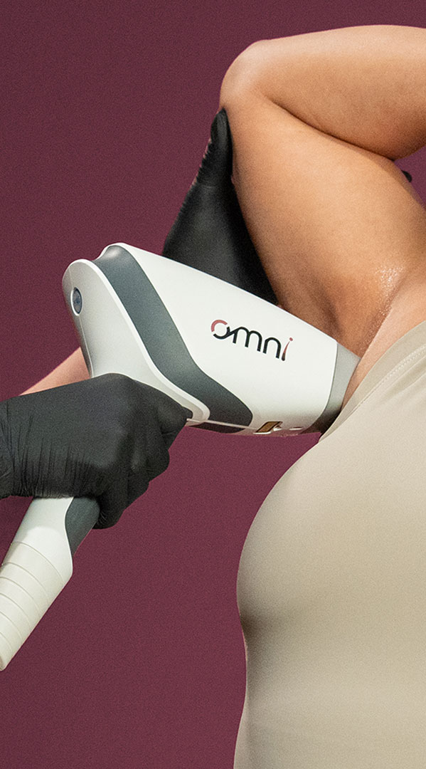 Sciton OMNI hair removal system handpiece removing hair from a woman's armpit